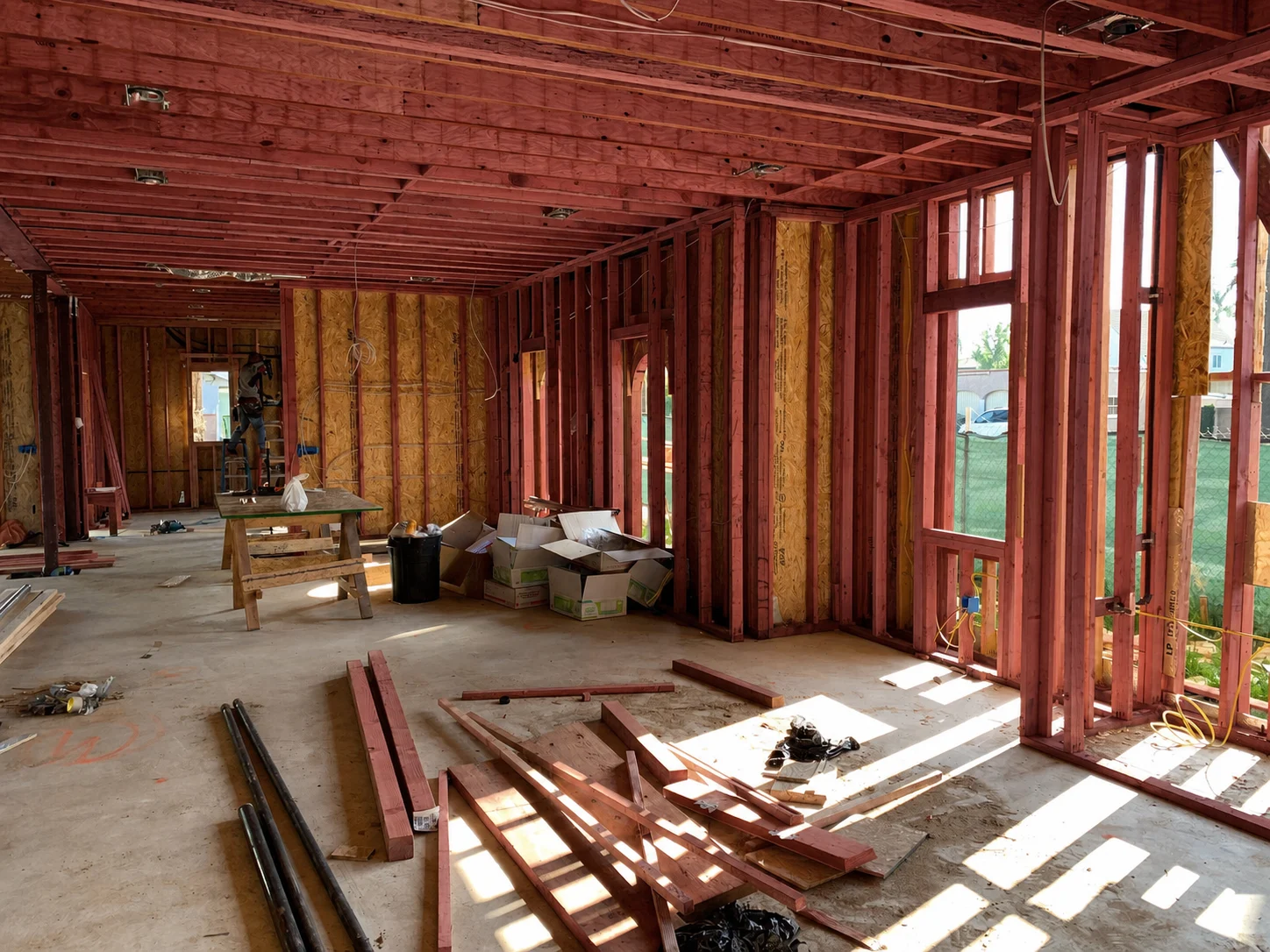 Authentic residential house frame with red fire-retardant-treated structural lumber